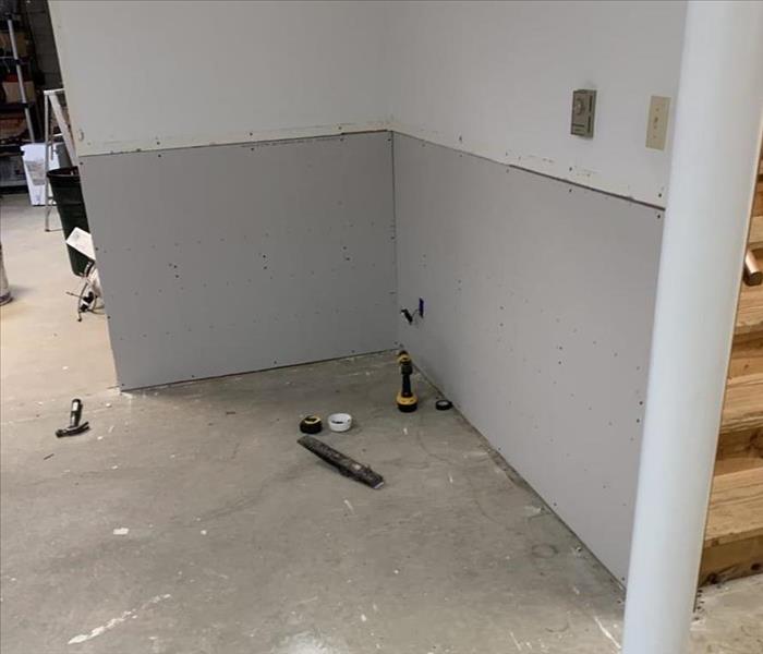 Corner of a room with new drywall being installed 