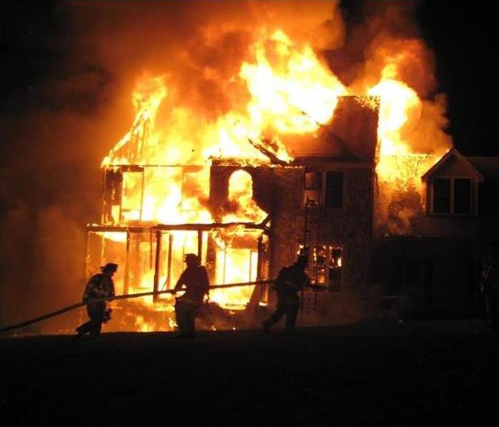 picture of a house completely engulfed in flames