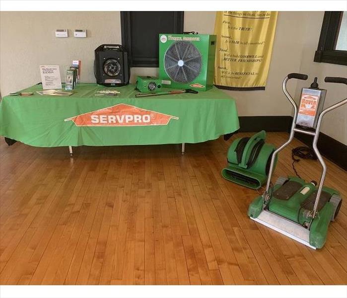 Table decorated with SERVRPO equipment and a SERVPRO table cloth