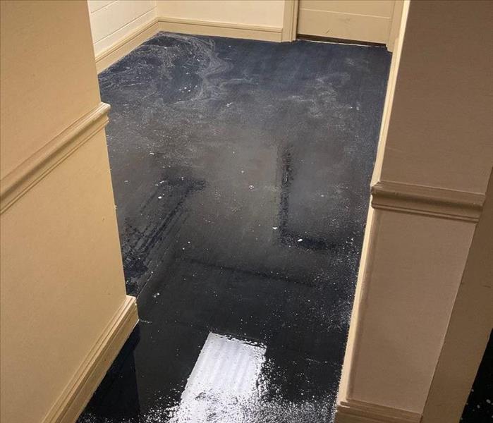 Flooded carpet in a coat room