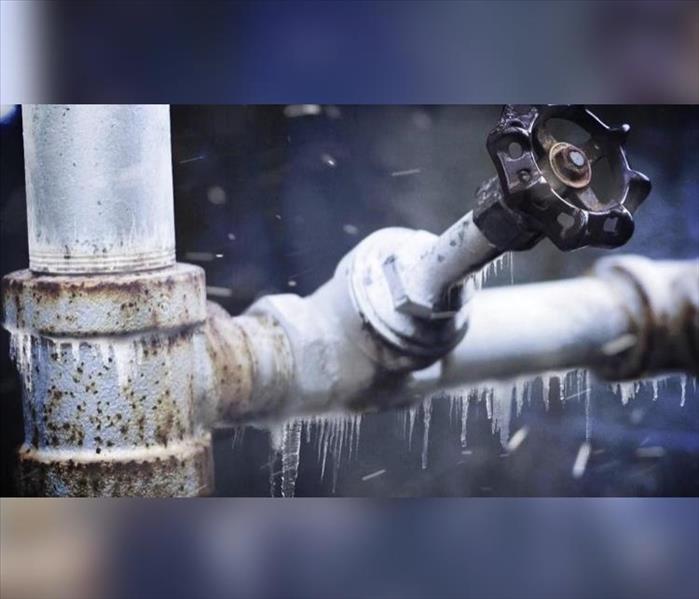 Photo of frozen pipe with ice on it