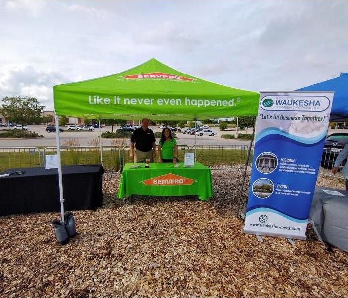 Two SERVPRO employees under a SERVPRO tent