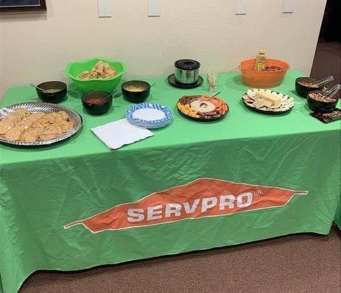 A SERVPRO green table cloth with snacks on the table