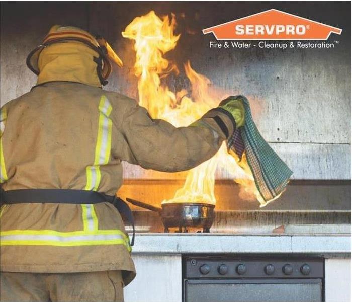 picture of a firefighter putting out a stove fire